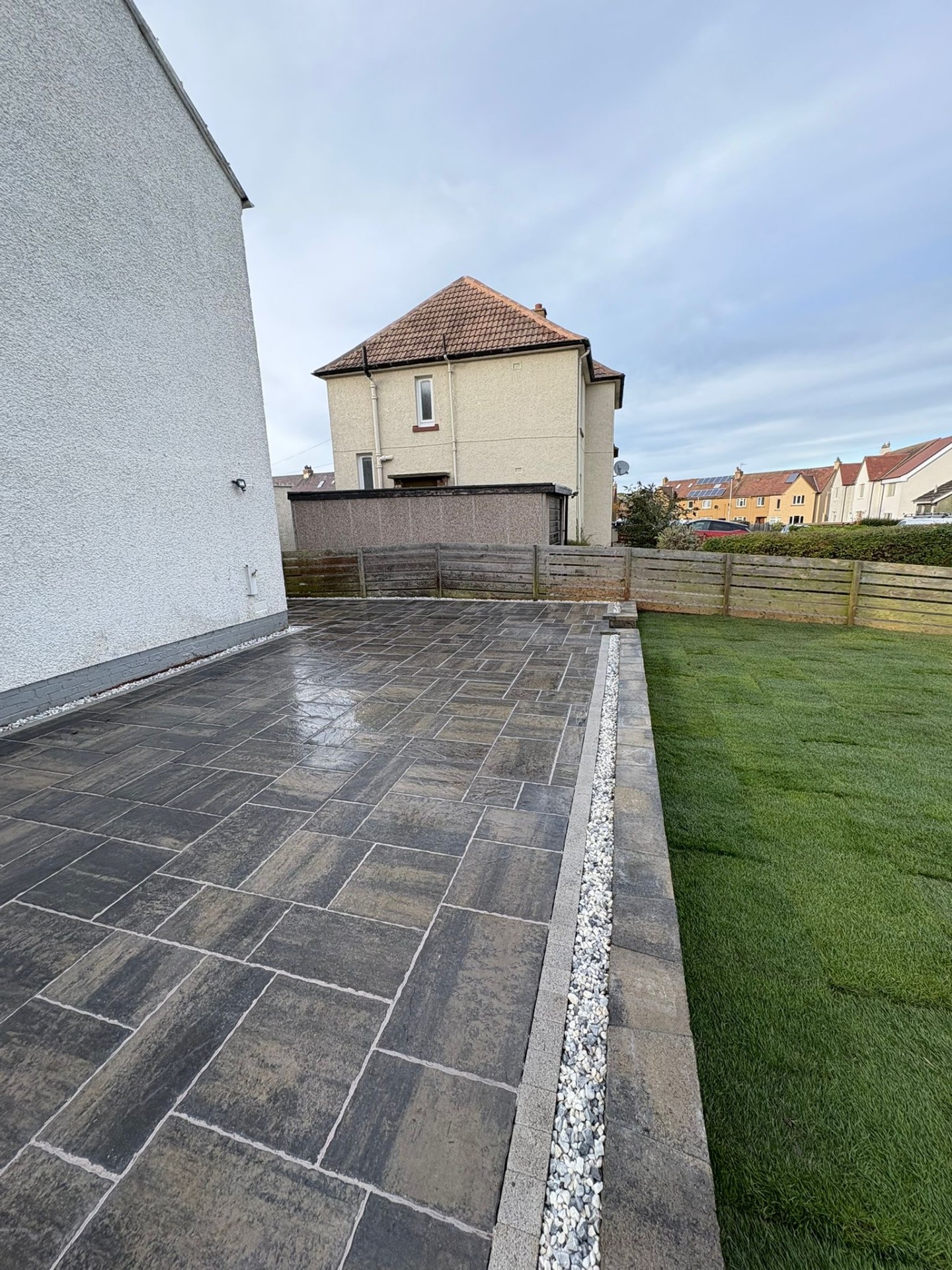 Side view of a stunning garden makeover in South Queensferry EH30 with Tobermore paving and turf.