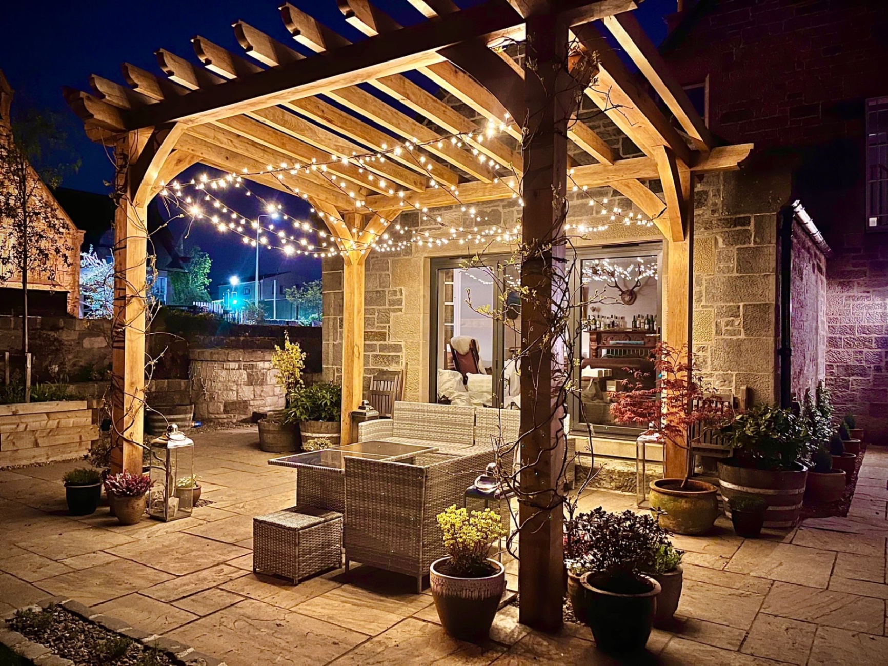 Oak pergola with festoon lighting for evening entertaining in Edinburgh garden