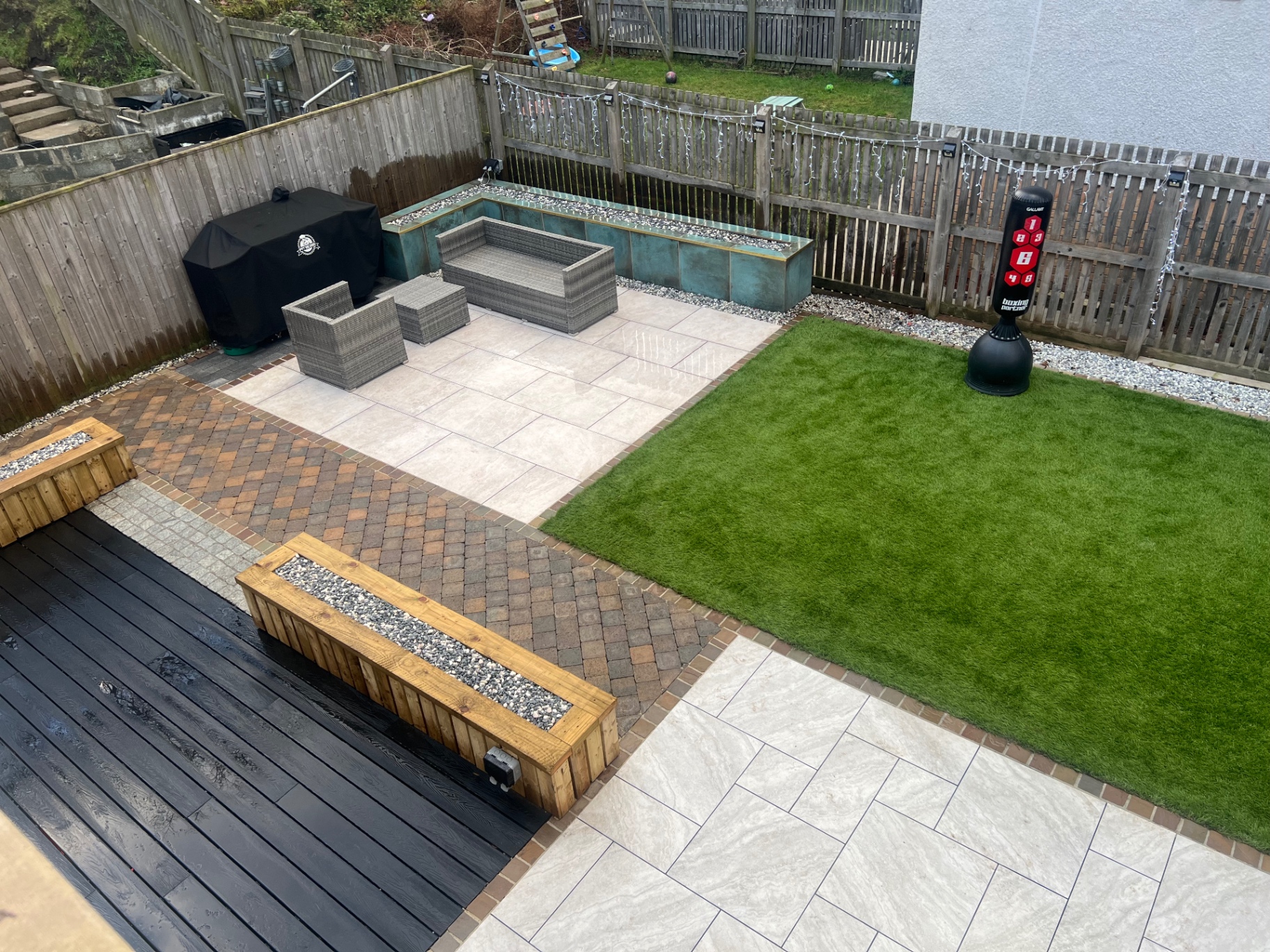 Porcelain paving with artificial grass and decking