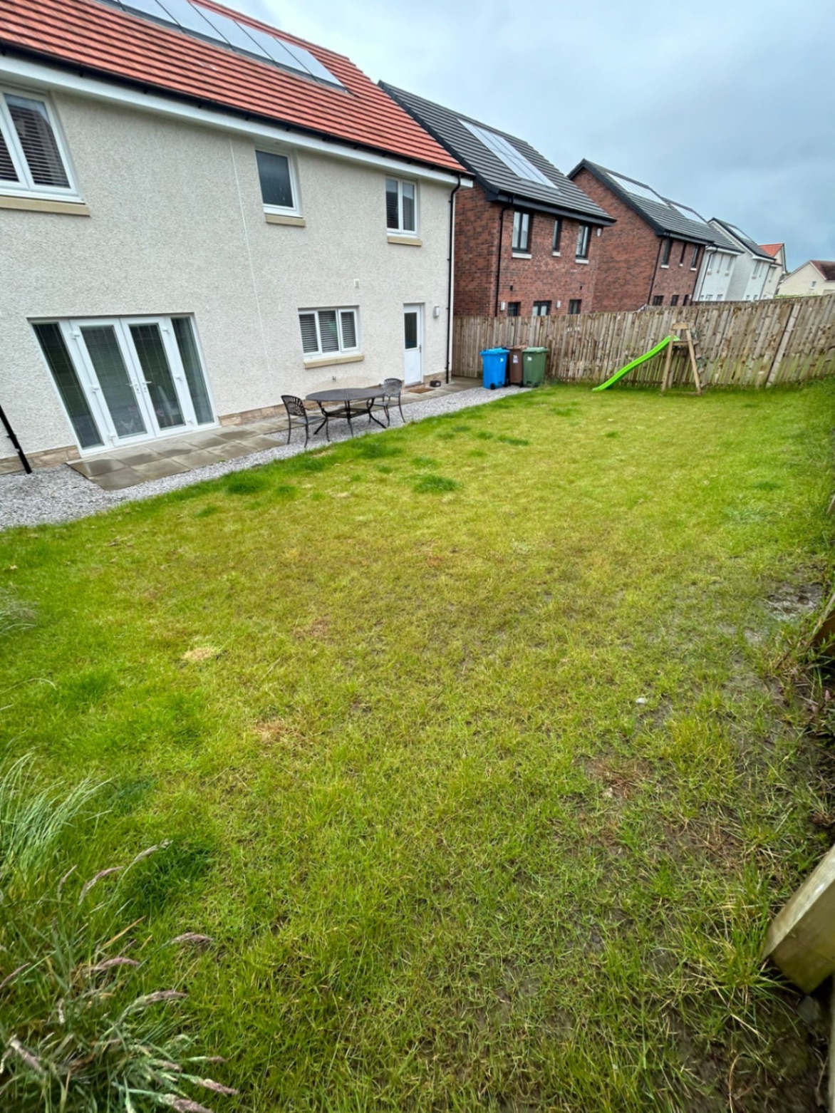 Sloping uneven lawn with poor drainage in Winchburgh newbuild garden before transformation