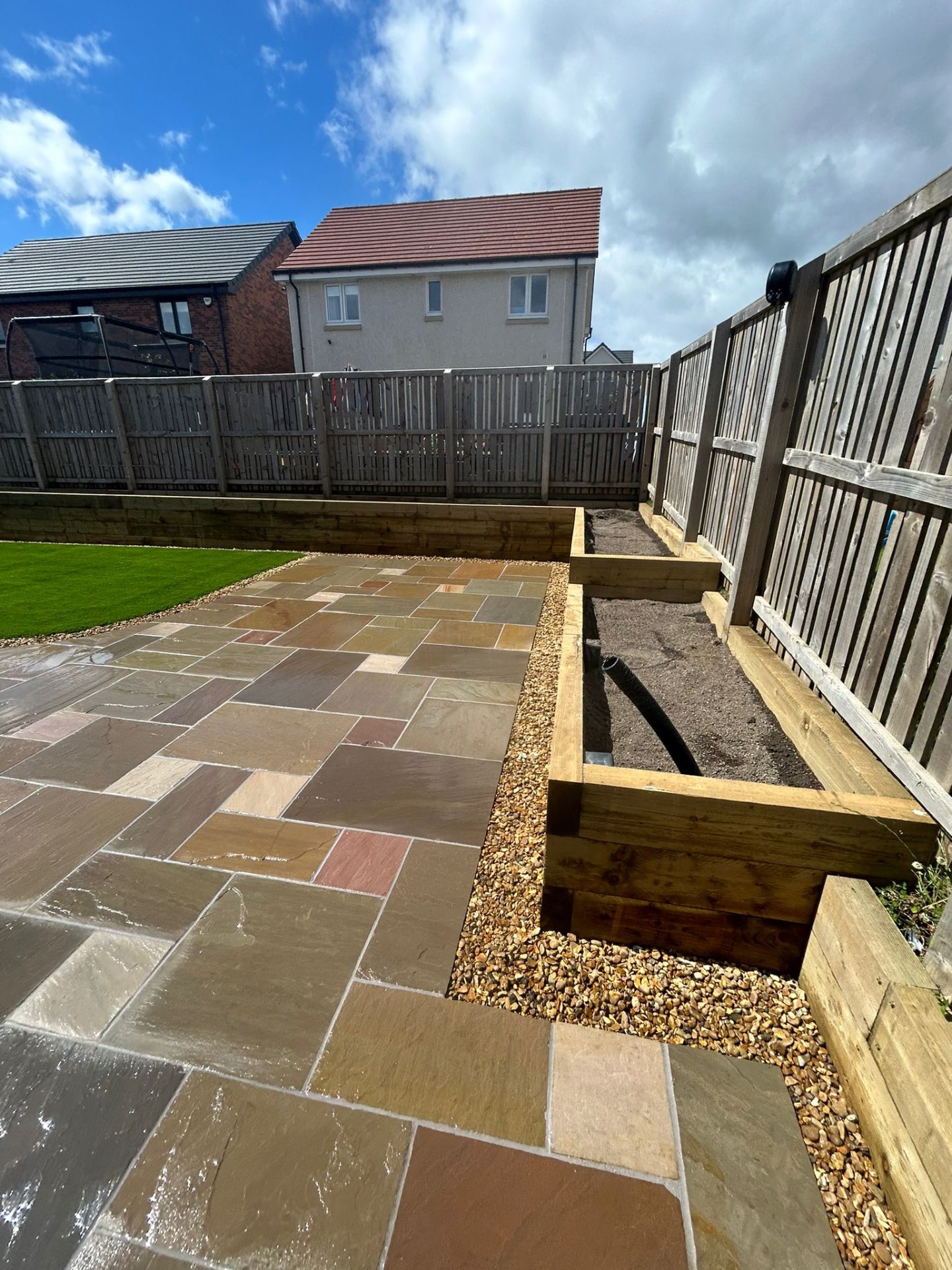 Timber sleeper raised beds with sandstone edging detail in Winchburgh garden transformation