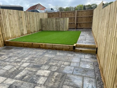"Experience the beauty and low-maintenance convenience of this stunning garden transformation in Stirling. Our expert team installed artificial grass, a timber fence, and Tobermore Historic Slate to create a space that is both visually appealing and easy to maintain. Enjoy the lush greenery of the artificial grass, the natural charm of the timber fence, and the timeless elegance of the Tobermore Historic Slate, all without the hassle of constant upkeep. Embrace a maintenance-free lifestyle and indulge in the beauty of this meticulously crafted garden."