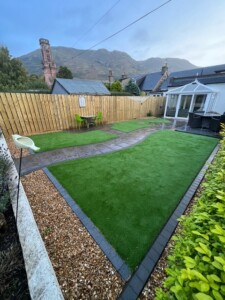 A breathtaking garden in Tillicoultry overlooking the majestic Ochil Hills. The garden features a lush green artificial grass lawn and a beautifully paved path.